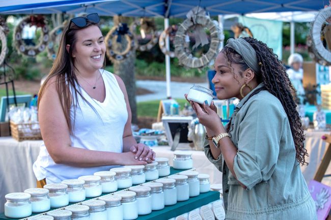 Candle vendor with customer at Farmers Market