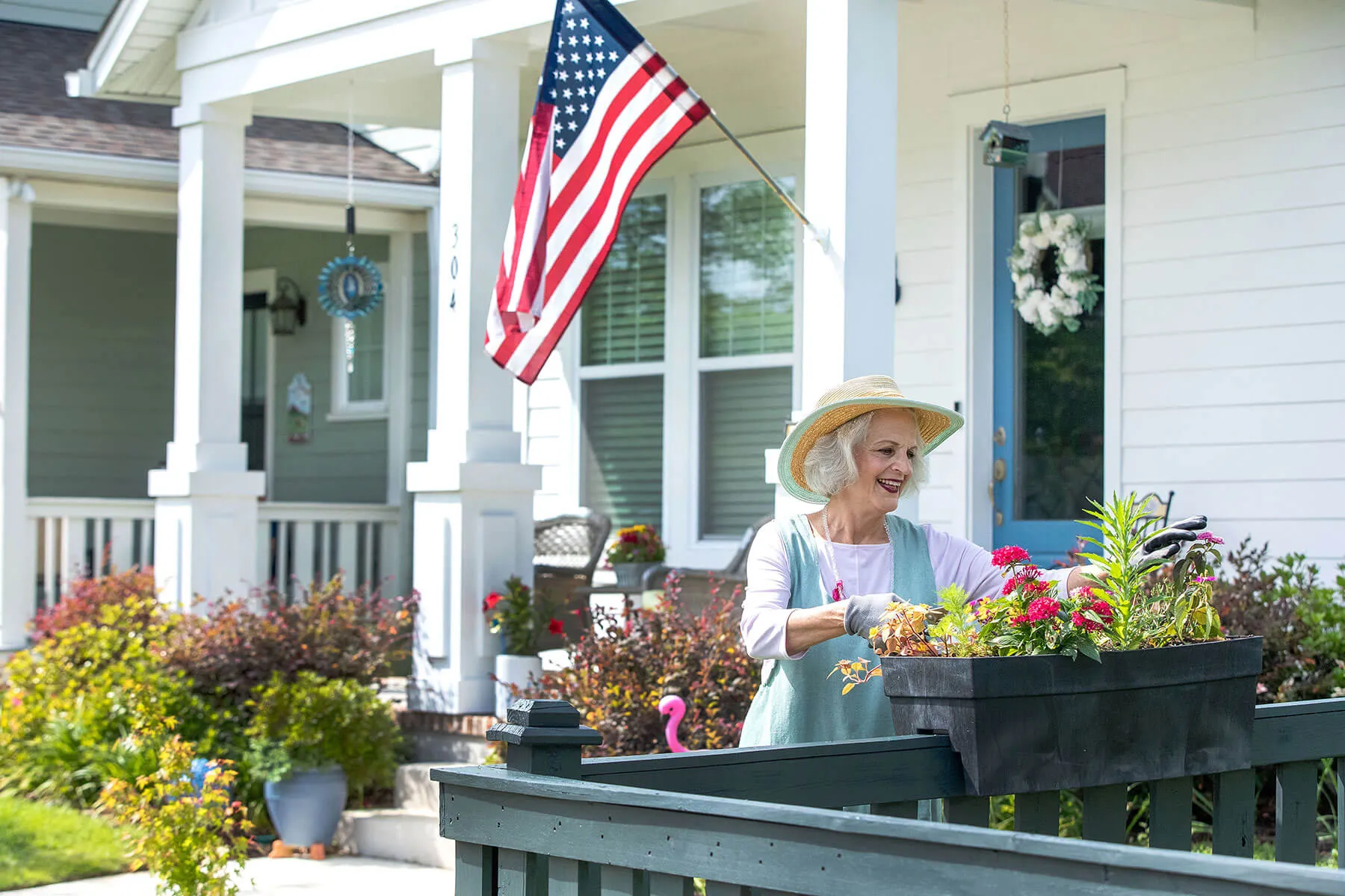 Woman gardening in front of her house