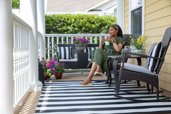 Woman with a coffee mug relaxing on porch