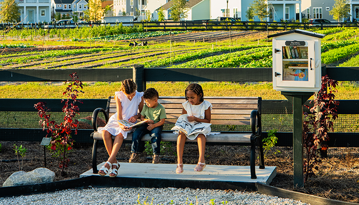 Kids reading at Learning Garden at Carnes Crossroads